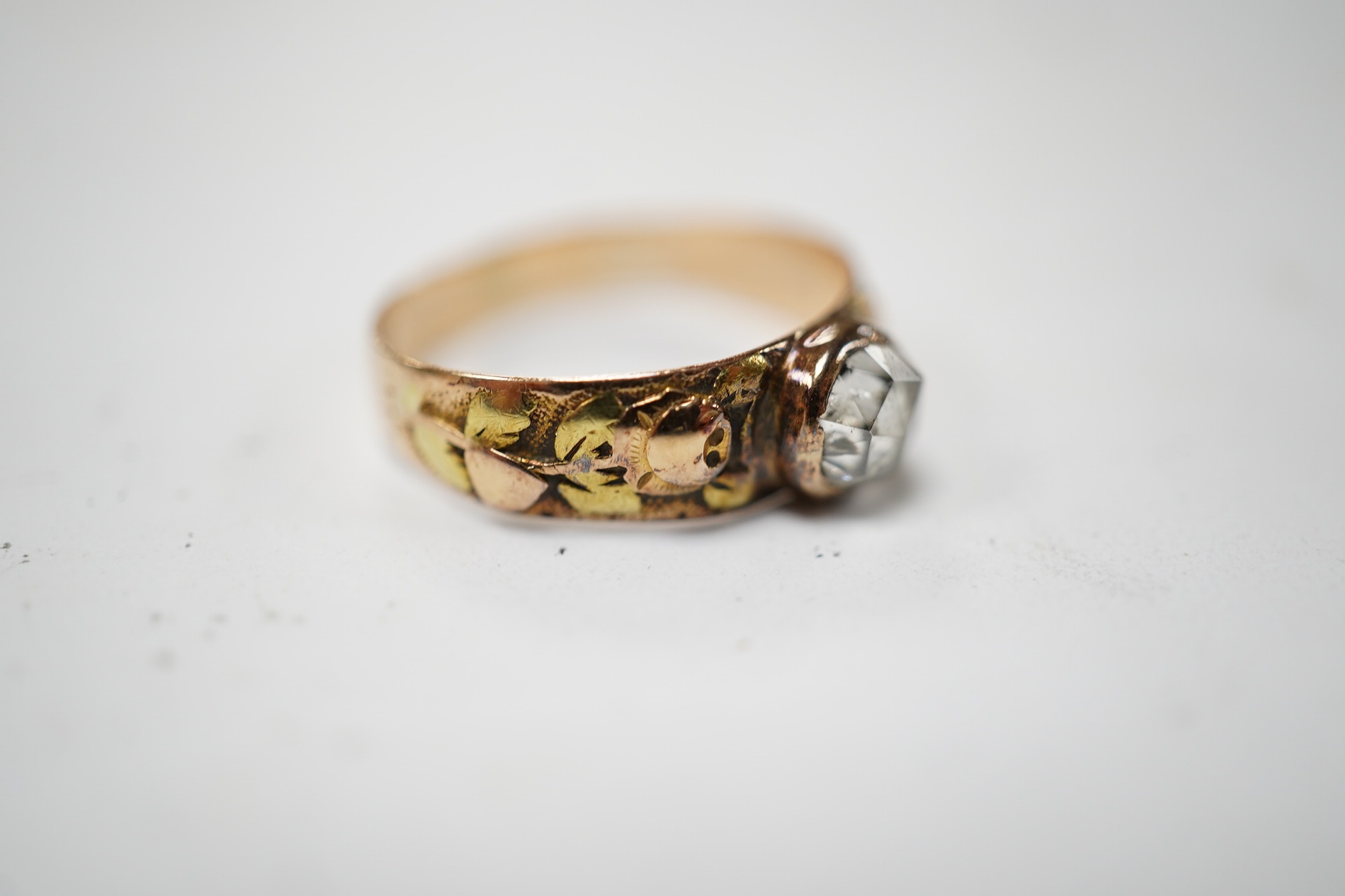 An antique two colour yellow metal and single stone rose cut diamond set ring, size I, gross weight 1.9 grams. Condition - fair